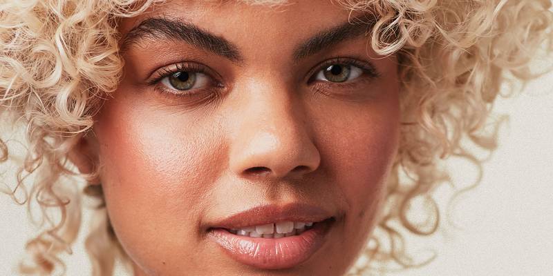 Close-up of a model with platinum blonde curls — Paul Mitchell Blonde