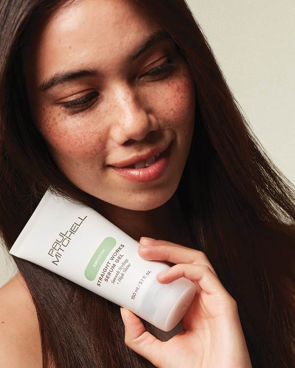 Model with long, straight dark hair and freckles — Paul Mitchell Smooth