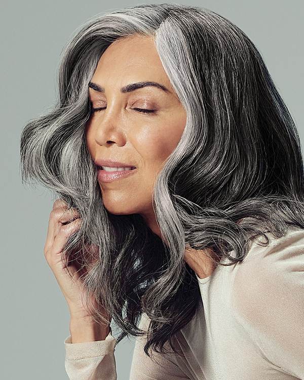 Model with full, silver-grey waves, eyes closed — Paul Mitchell